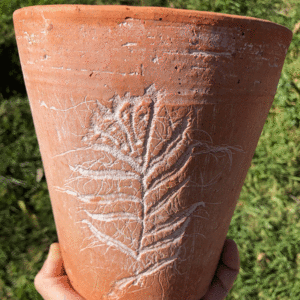 Terracotta pot with flower motif